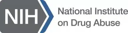 NIH logo next to the text National Institute on Drug Abuse on a white background.